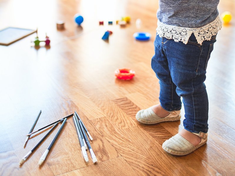 kid playing with toys on a vinyl floor from Carolina Flooring and Interiors in Grandy, NC area