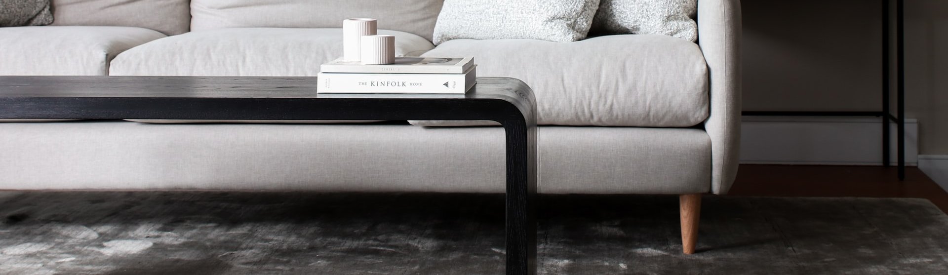 white couch and black coffee table on a brown hardwood floor from Carolina Flooring and Interiors in Grandy, NC area